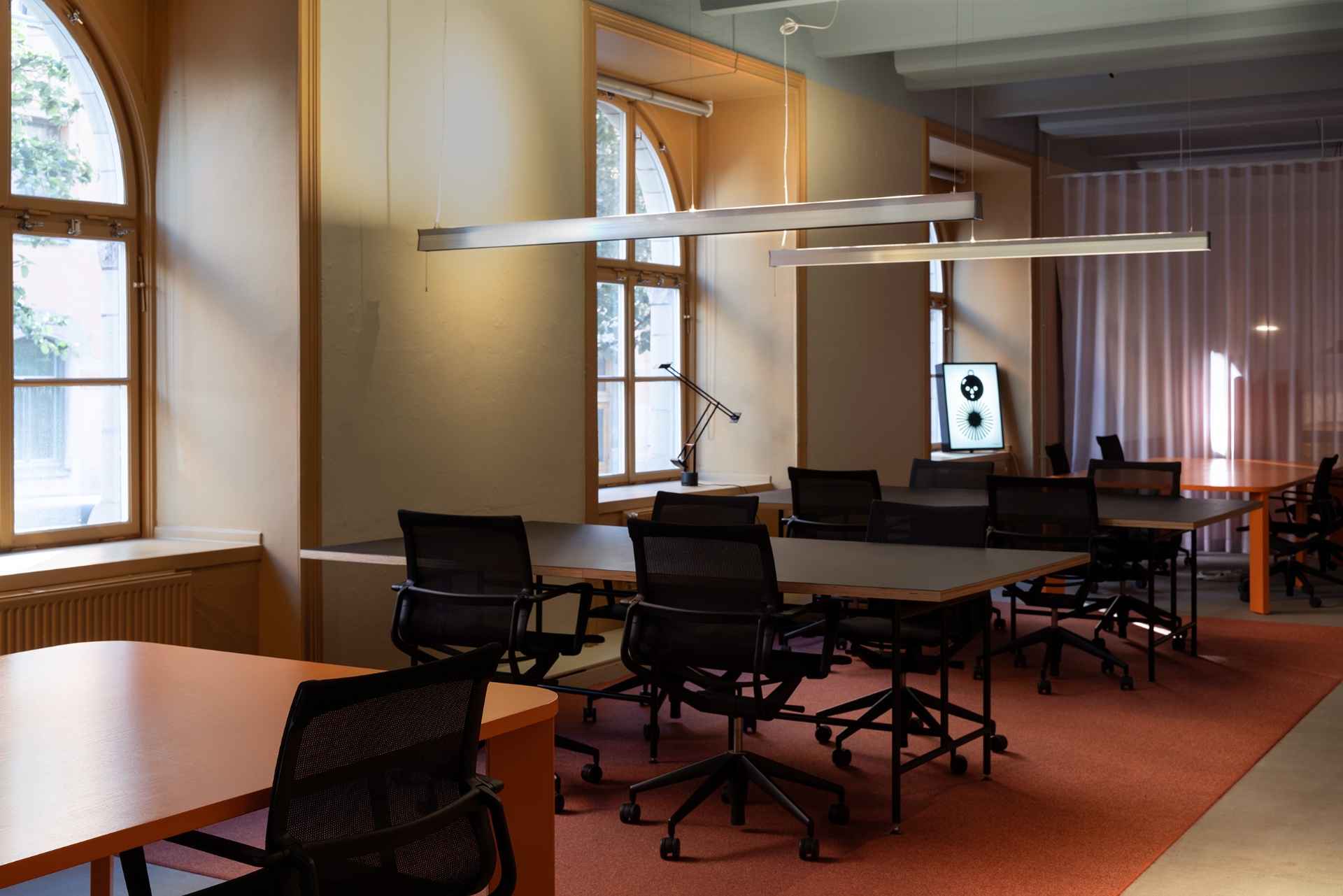 Open workspace with arched windows at Acne Advertising