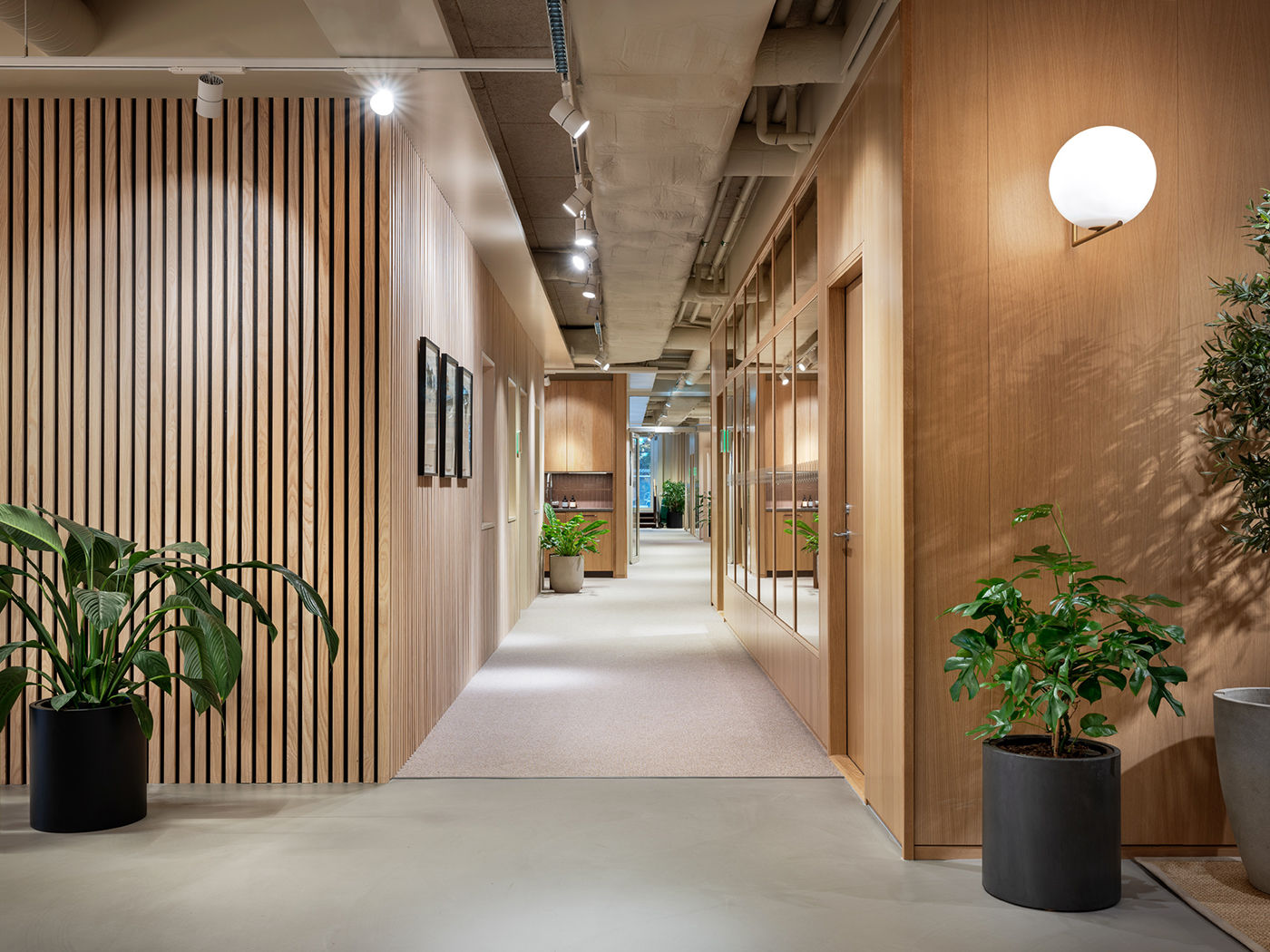 Wood-panelled corridor with globe sconce