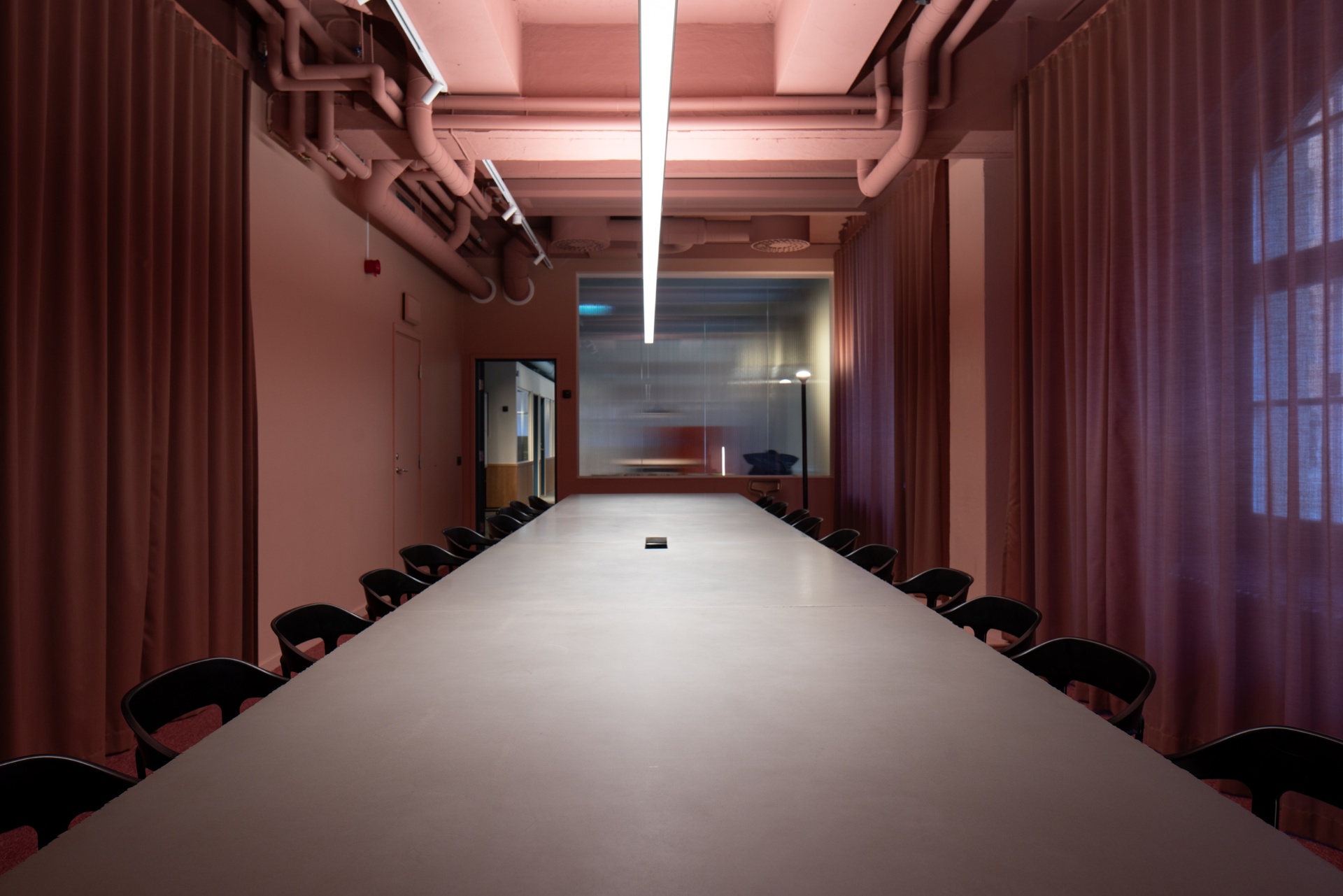 Long meeting room in pink at Acne Advertising