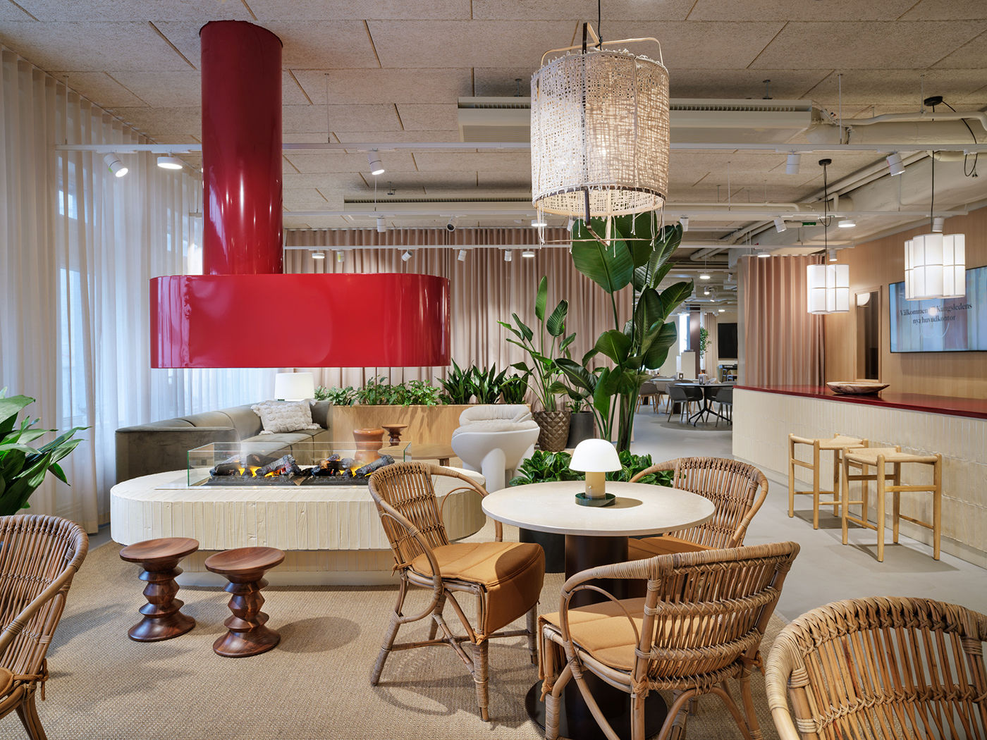 Kungsleden HQ lounge with red fireplace and rattan chairs