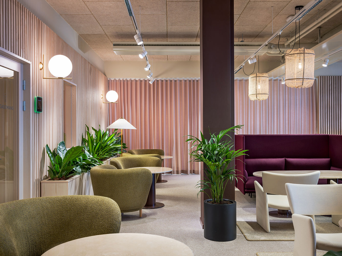 Lounge with pink curtains and burgundy banquette